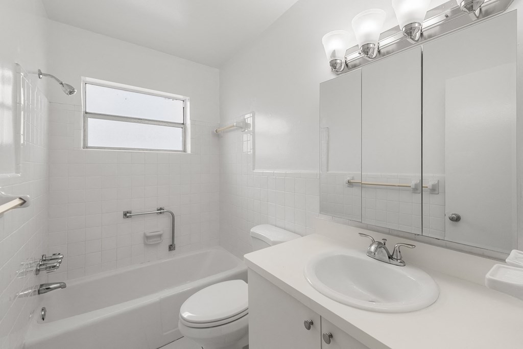 an empty bathroom with a sink toilet and bath tub