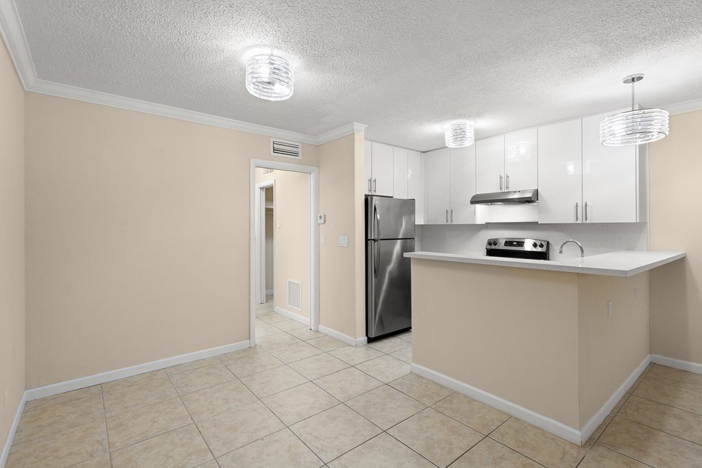 a kitchen with a stainless steel refrigerator and a counter top