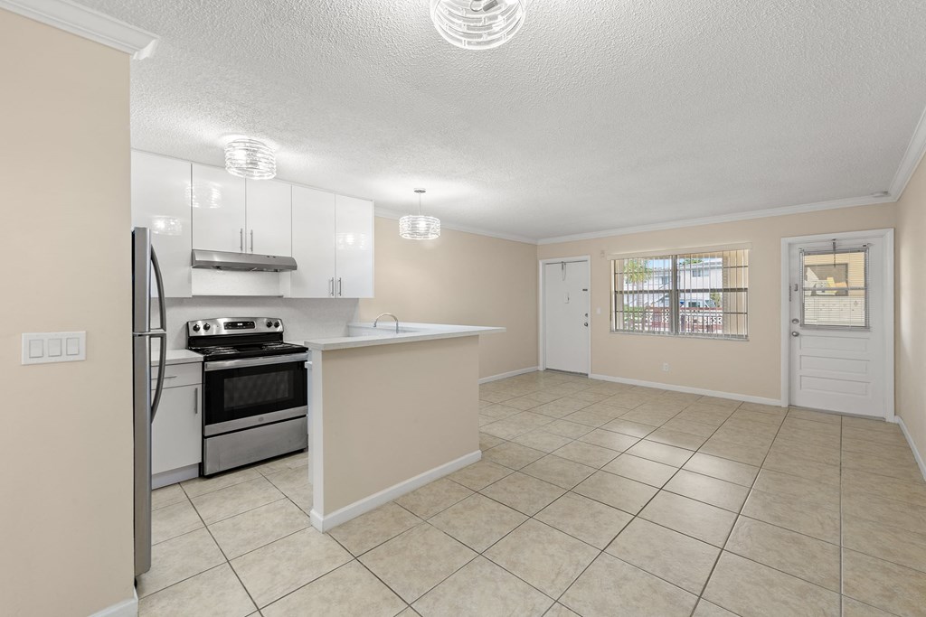 a kitchen with an island and a stove and a refrigerator