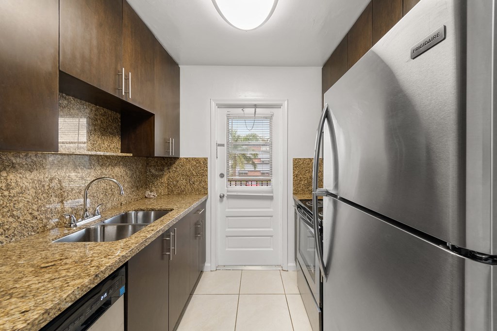 a kitchen with stainless steel appliances and granite counter tops