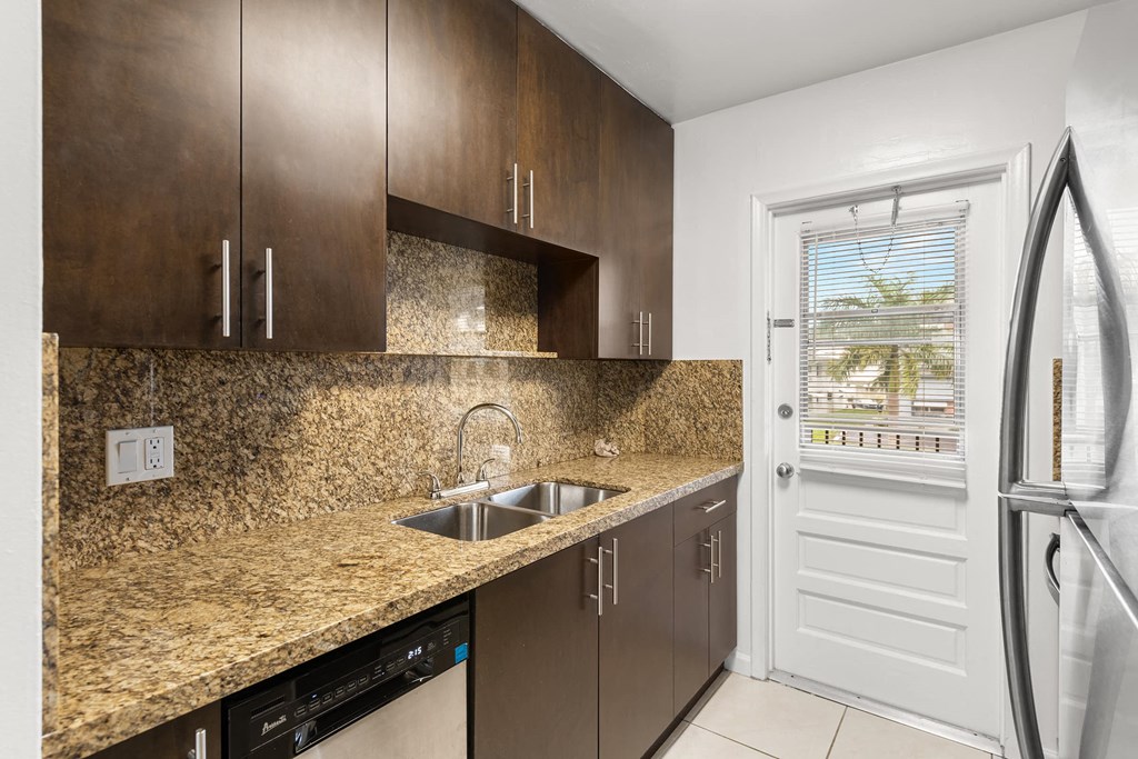 a kitchen with a sink and a refrigerator