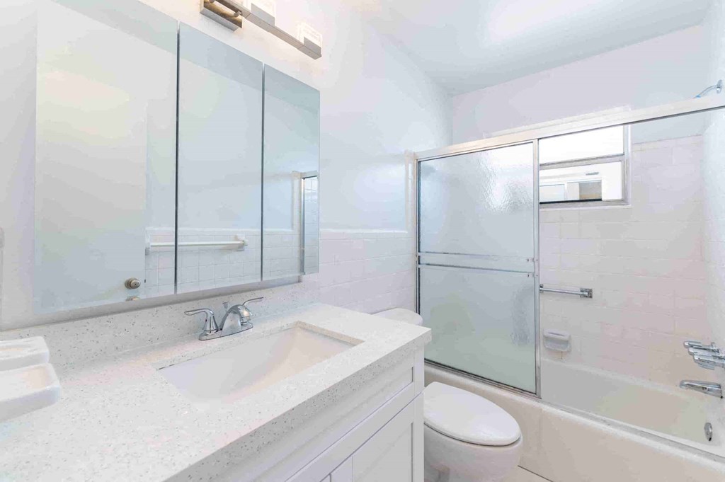 a bathroom with a sink toilet and a shower