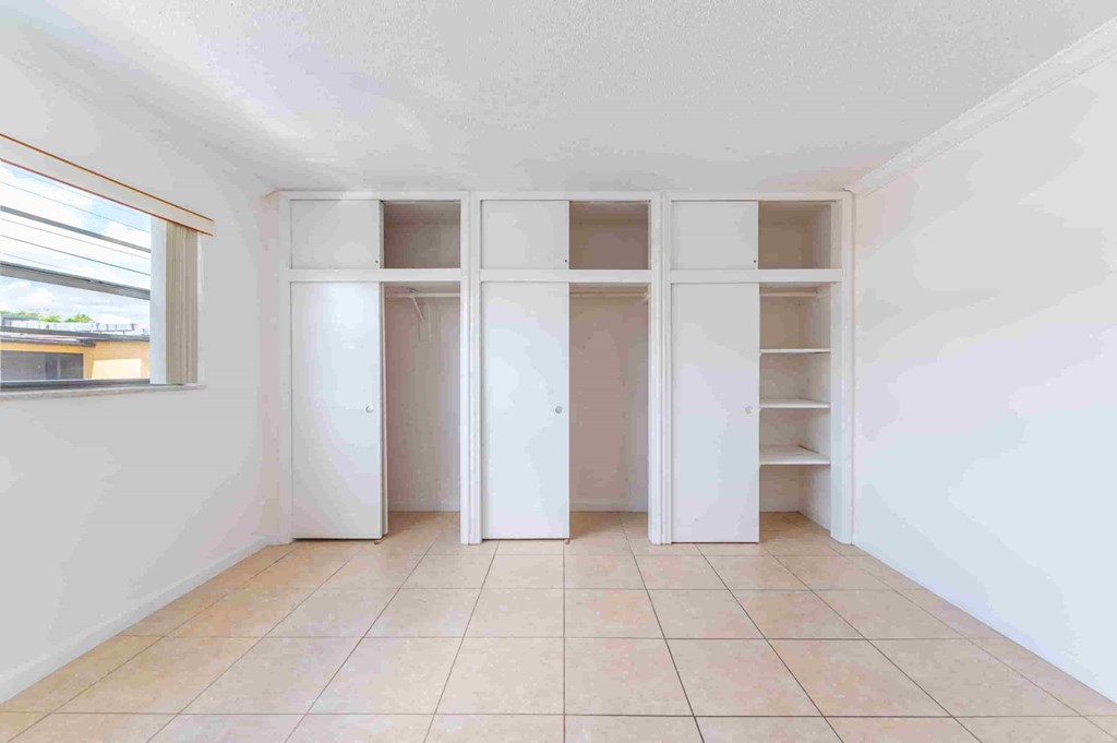 an empty room with white walls and shelves in it