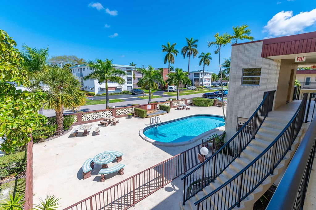 a resort style swimming pool with palm trees