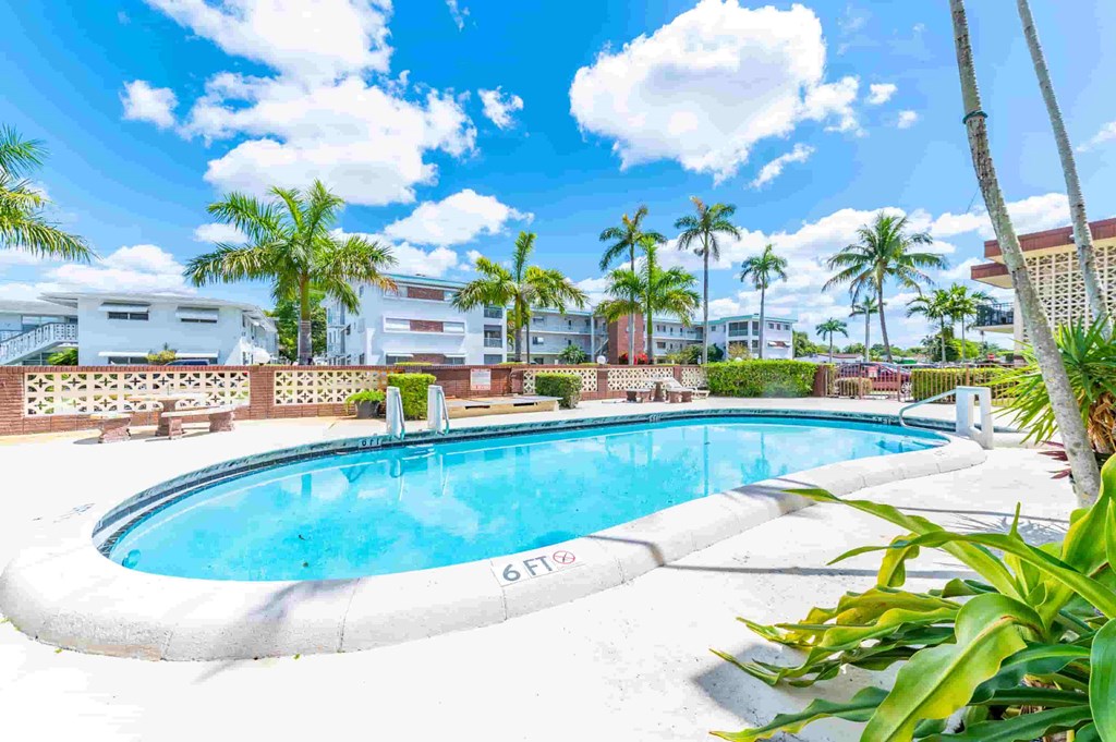 a swimming pool at a resort with palm trees