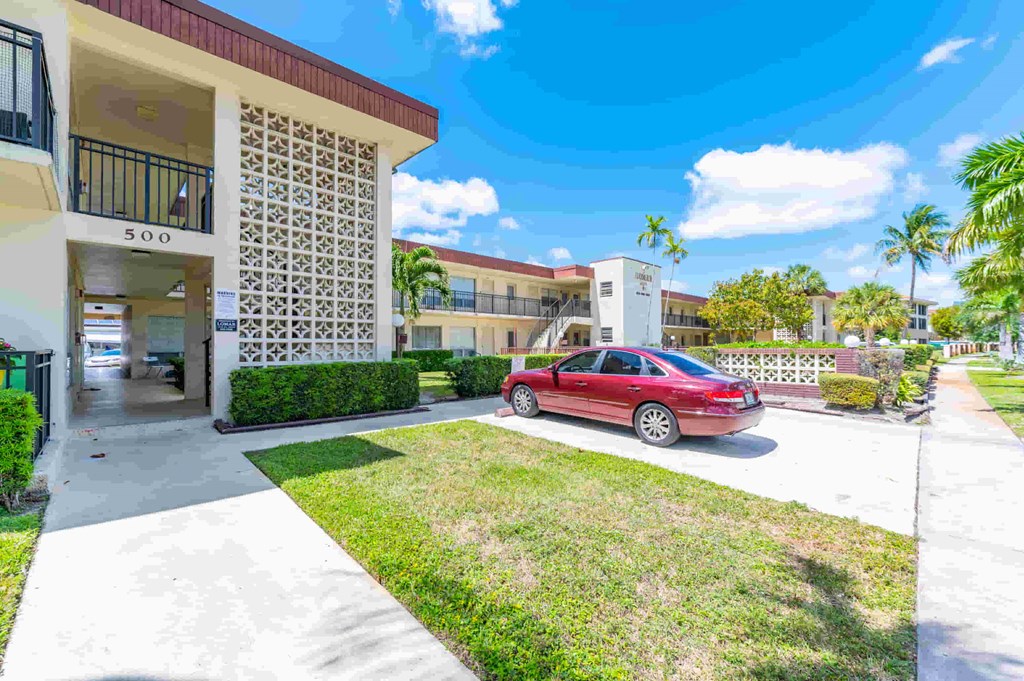 a red car parked in front of a building