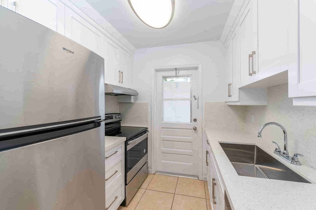 a kitchen with a sink and a refrigerator