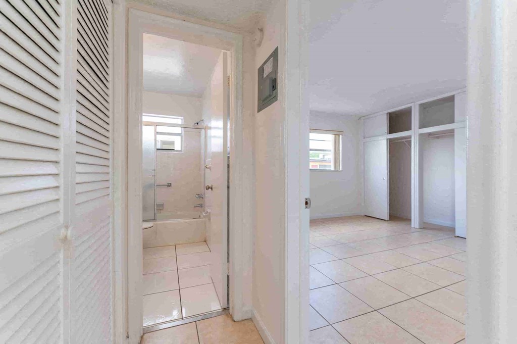 a bedroom with a bathroom and a closet