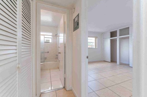 a bedroom with a bathroom and a closet