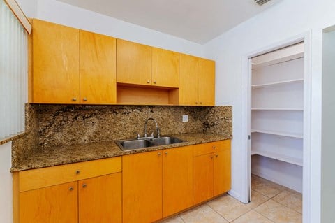 a kitchen with a sink and wooden cabinets