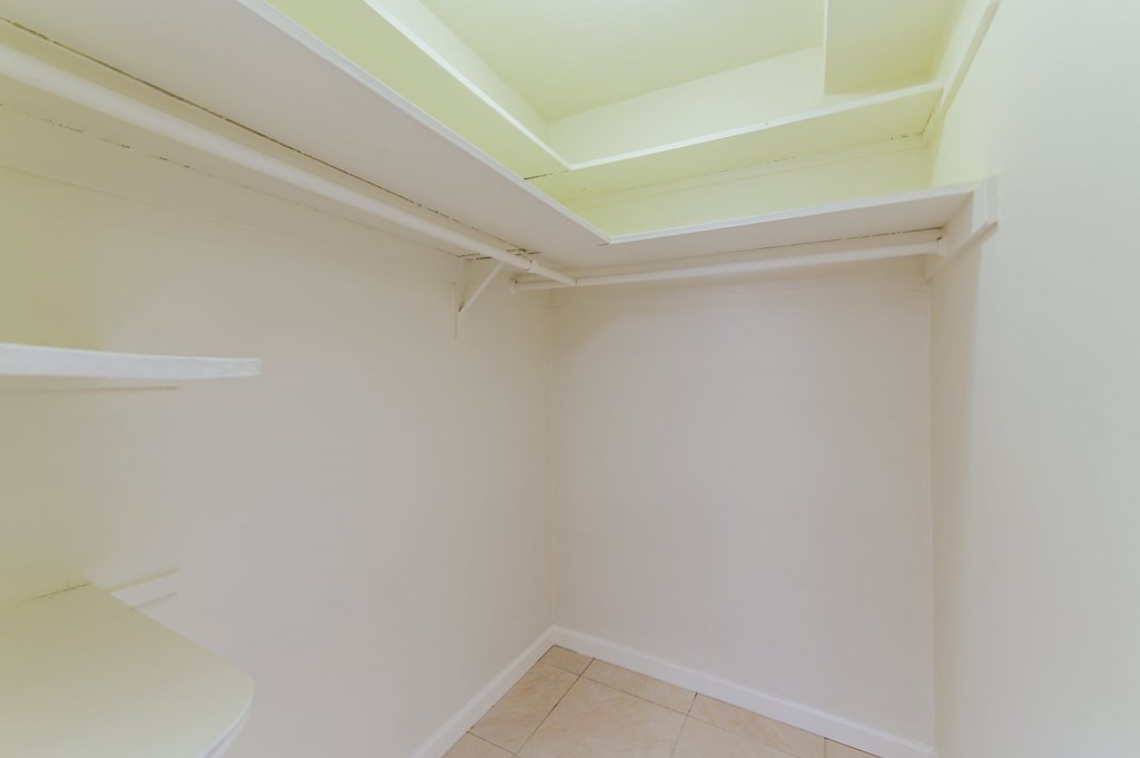 a small bathroom with a toilet and a white wall