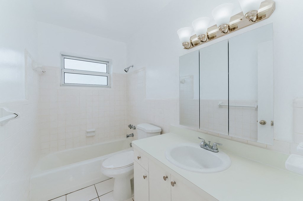 a bathroom with a sink toilet and a bath tub