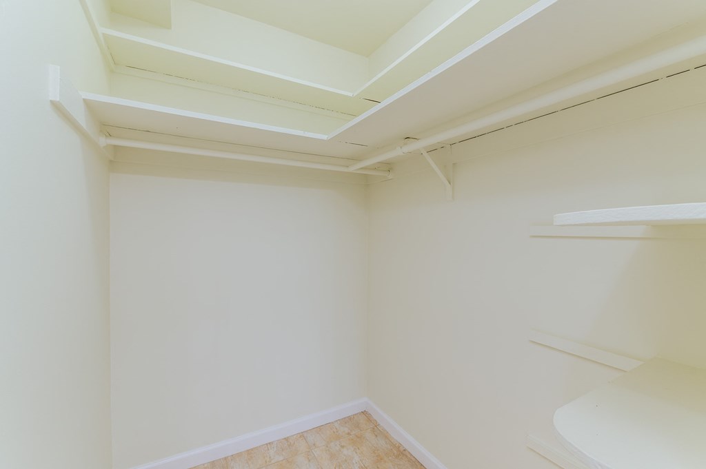 a bathroom with white walls and a sink and a toilet