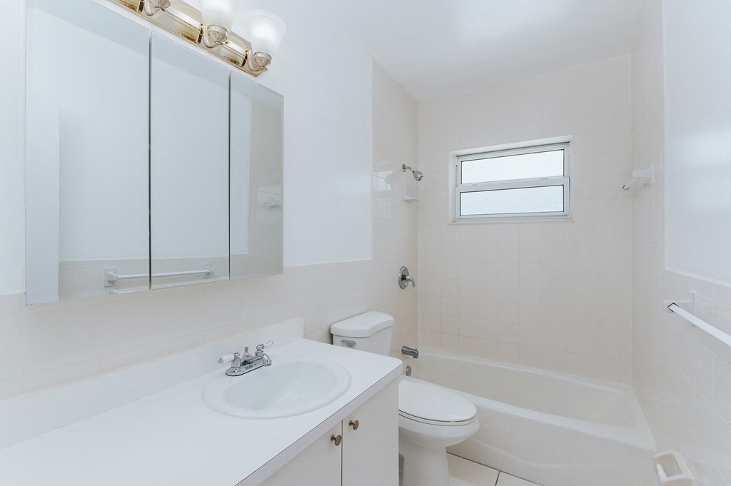a bathroom with a sink toilet and a tub