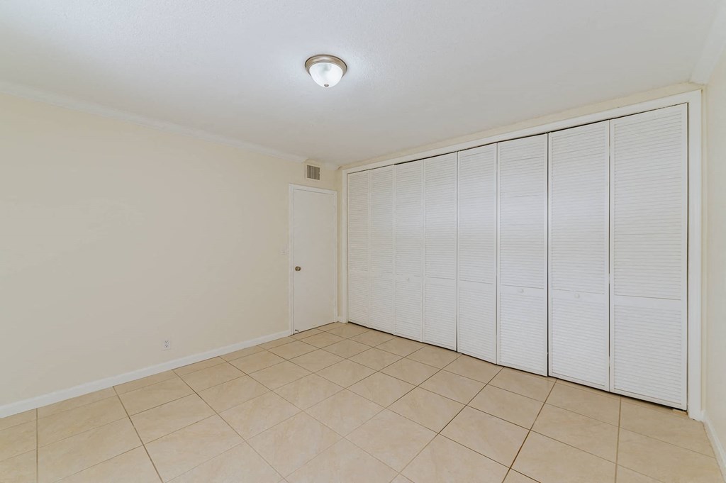 the living room has a large closet with shuttered doors