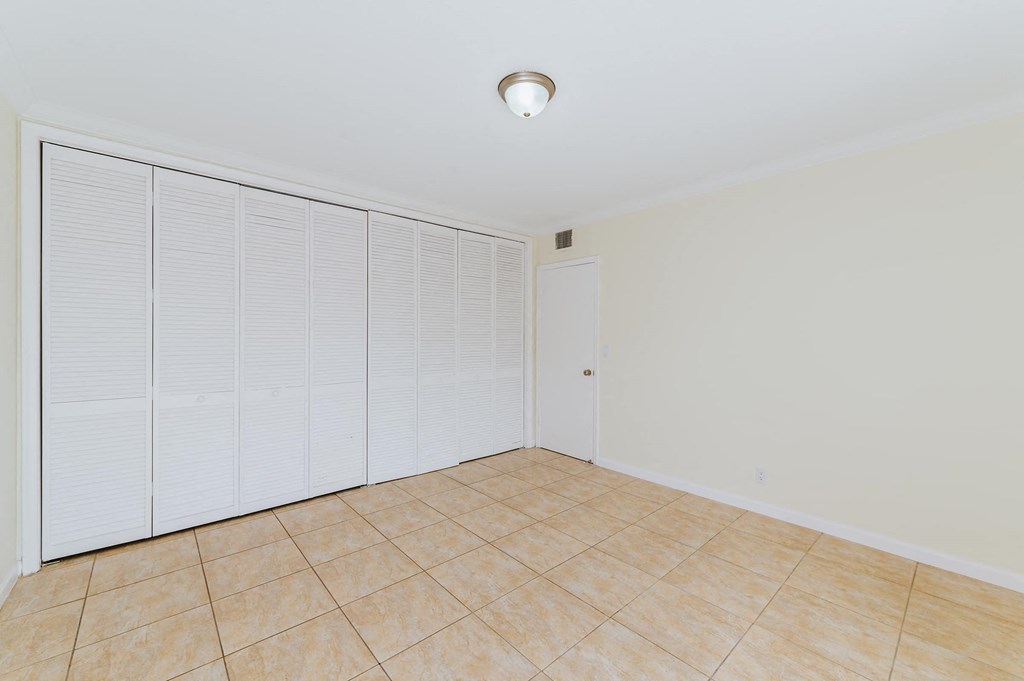 a large room with a large closet and a tile floor