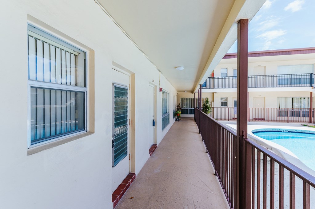 a corridor with a pool at the end of a building