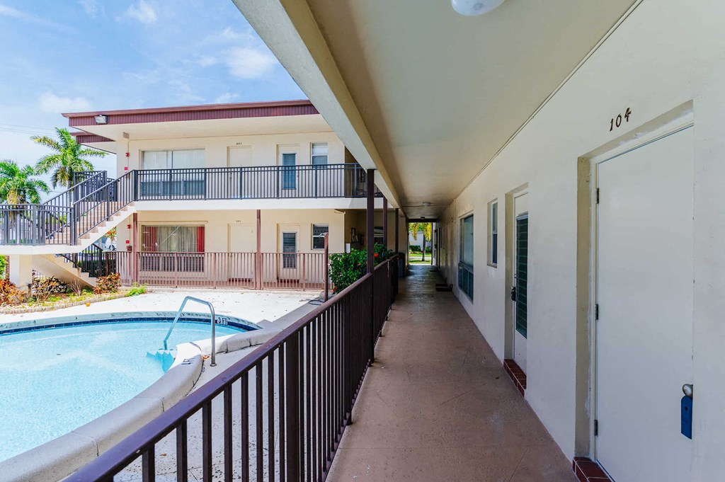 a building with a pool and a corridor with a door