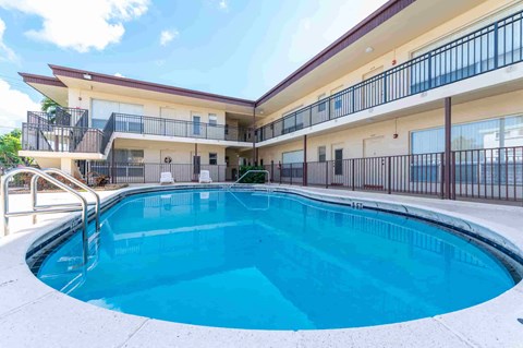 the swimming pool at our apartments with a blue pool