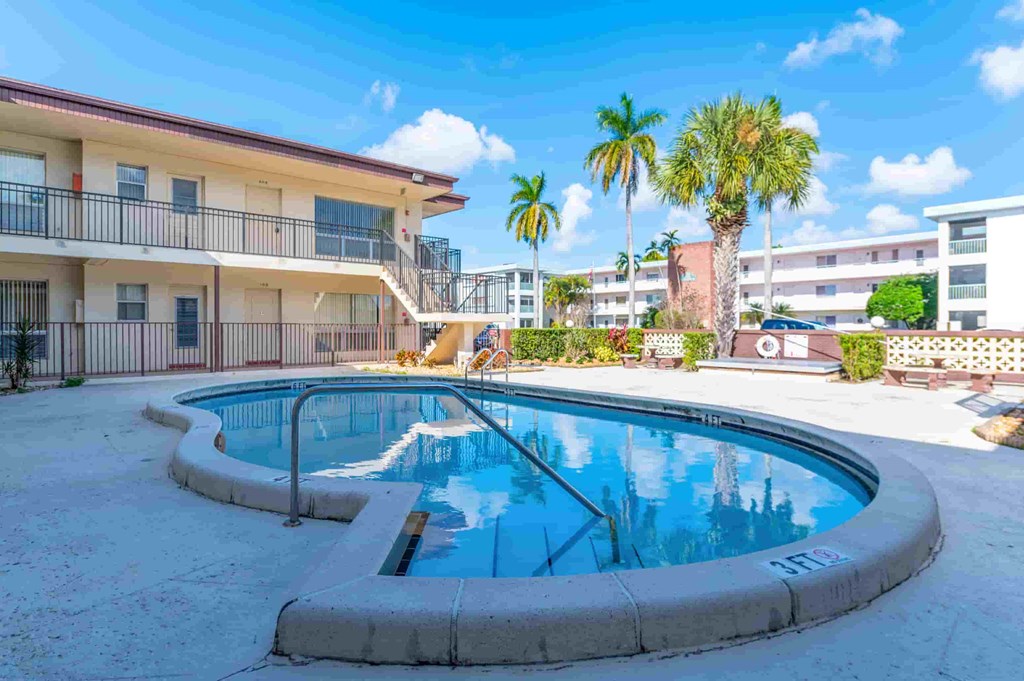a swimming pool with a building in the background