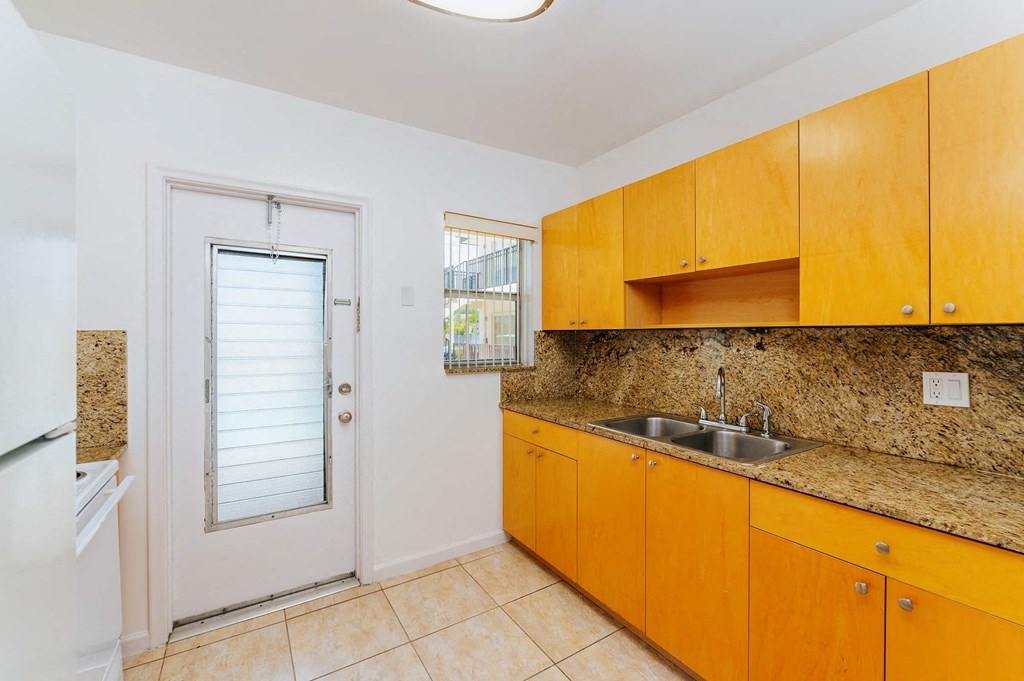 a kitchen with a sink and a door