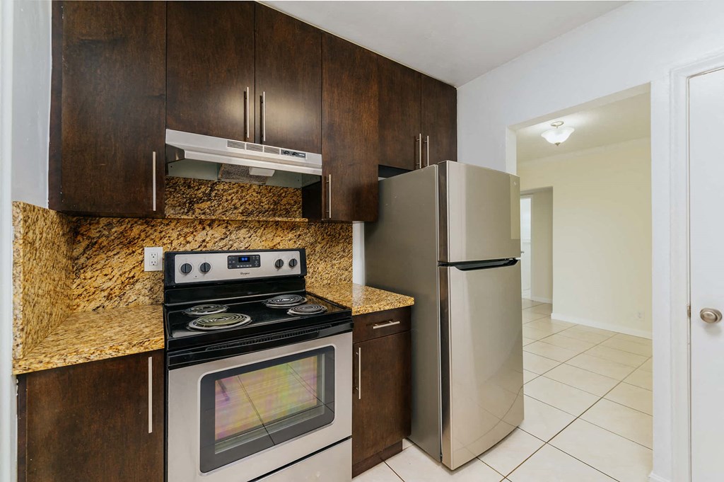 a kitchen with a stove and a refrigerator
