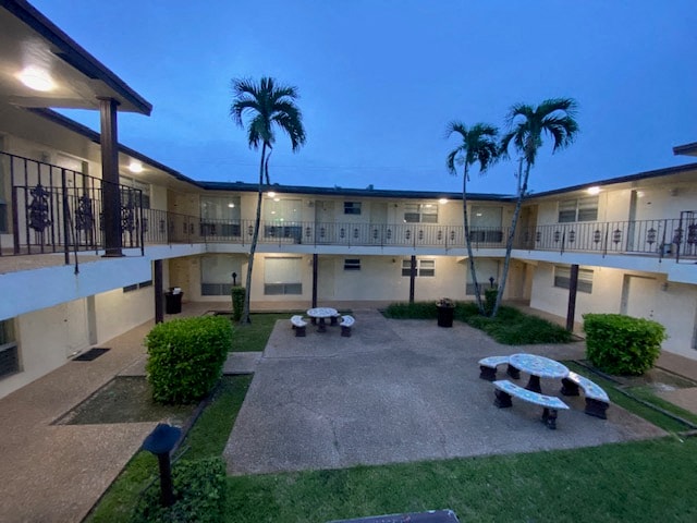 the courtyard of an apartment building with tables and benches