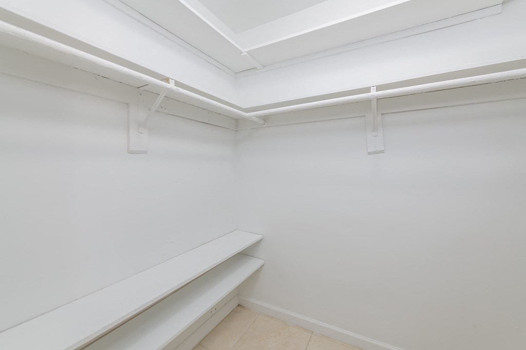 a room with white walls and a white shelf on the wall