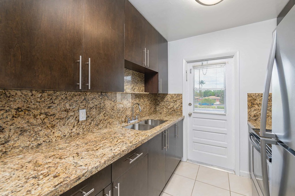 a kitchen with a sink and a door