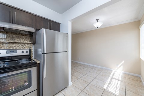 a kitchen with stainless steel appliances and a refrigerator