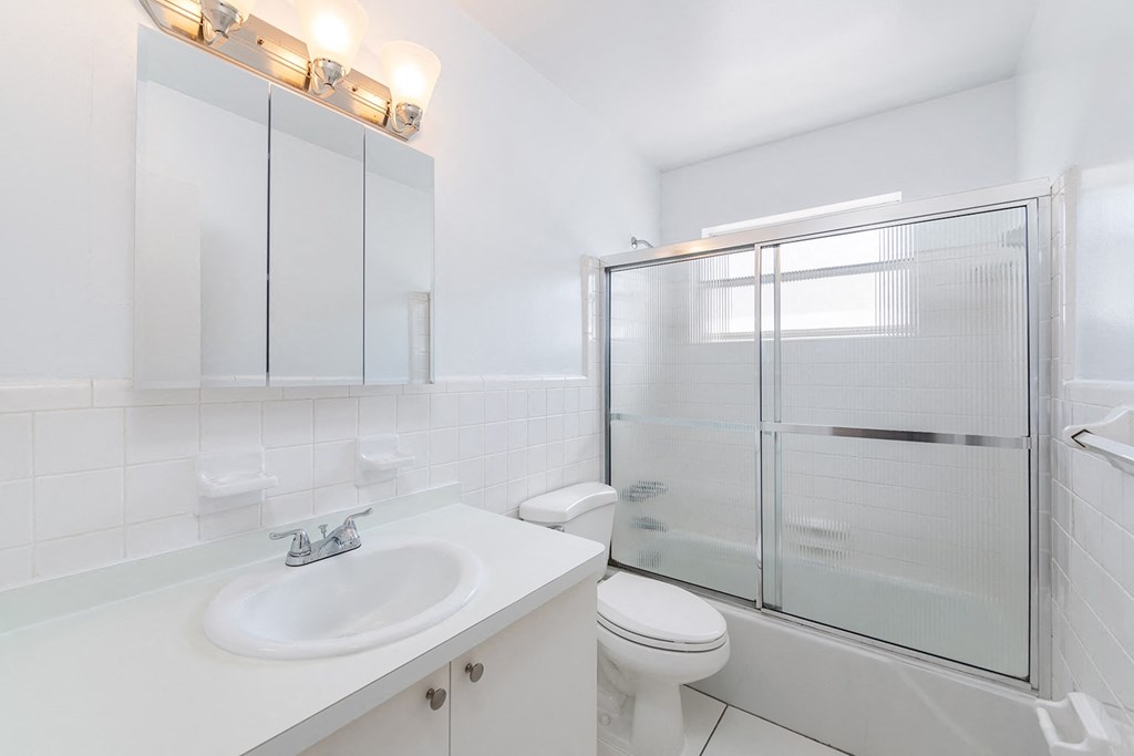 a bathroom with a sink toilet and shower