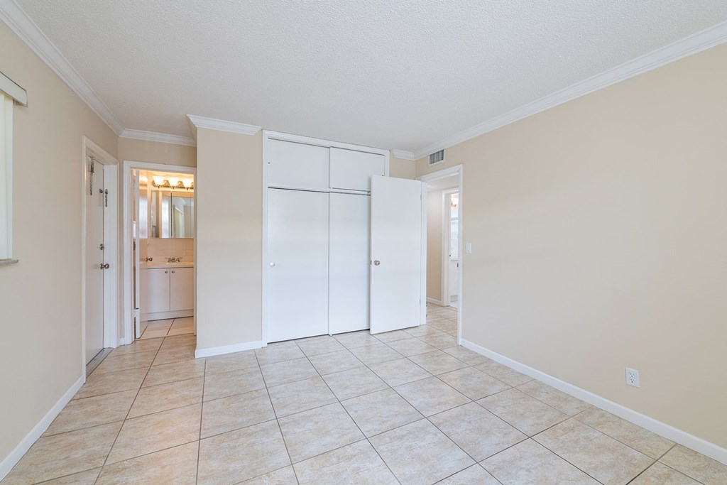 the living room and kitchen of an empty house with white doors