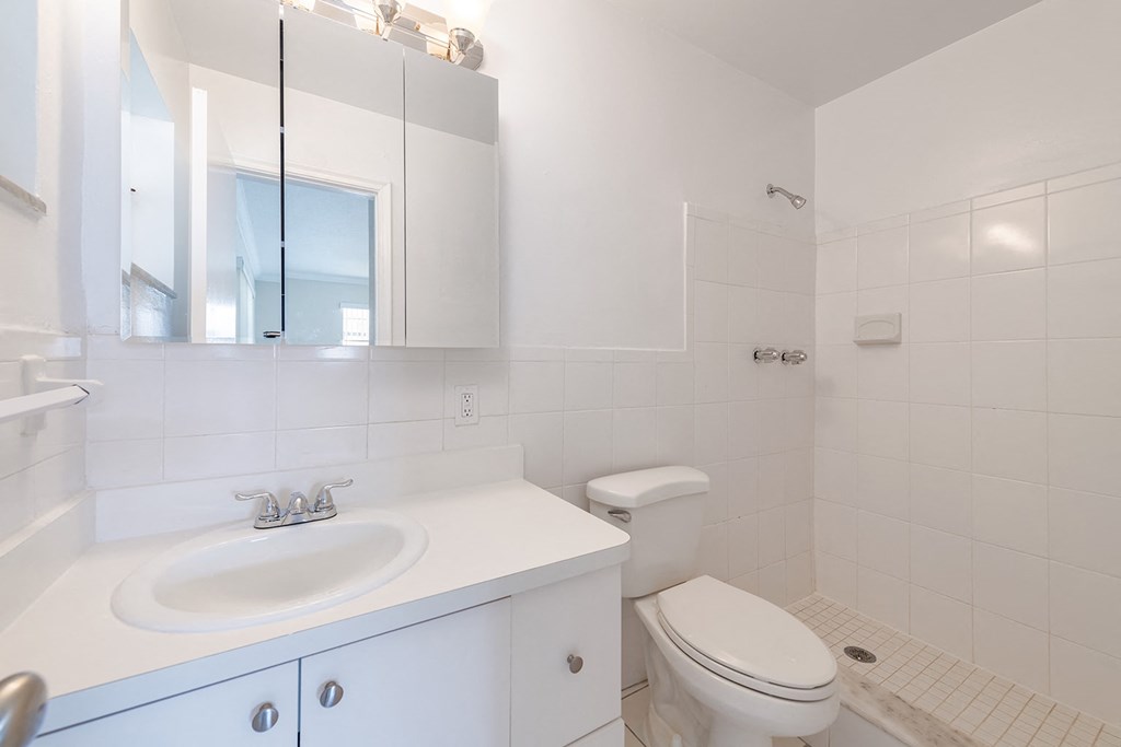 a bathroom with a sink toilet and a mirror