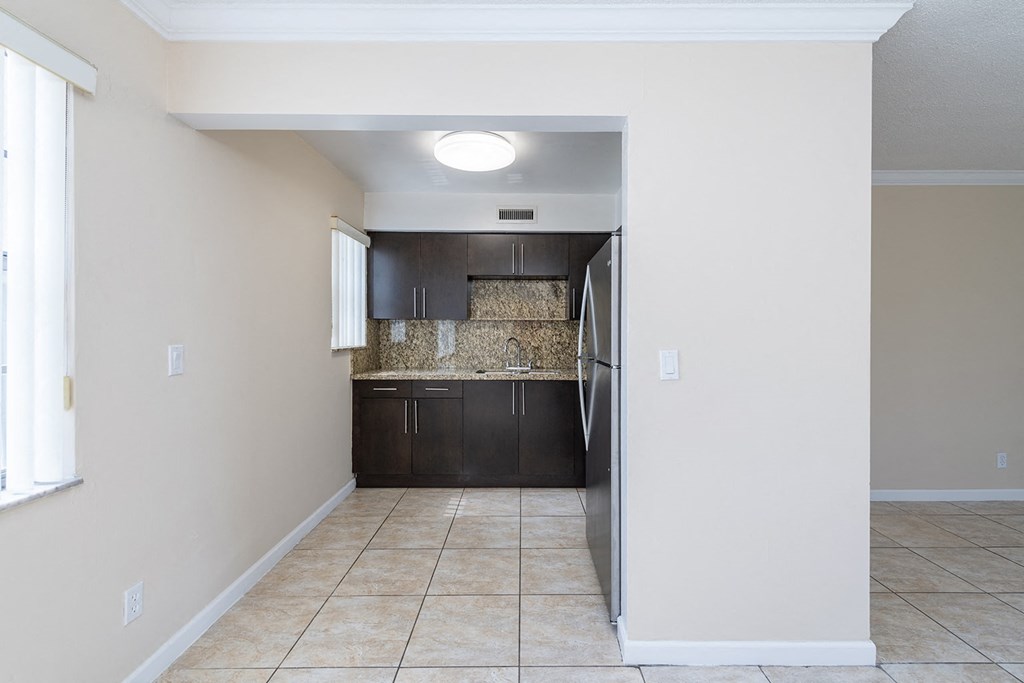 a view of a kitchen from the hallway of a house