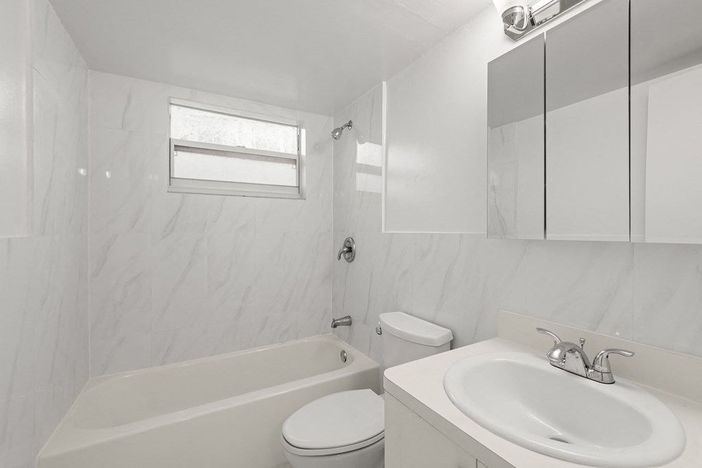 a bathroom with a sink toilet and a bath tub