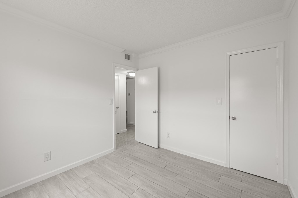 a bedroom with white walls and white doors