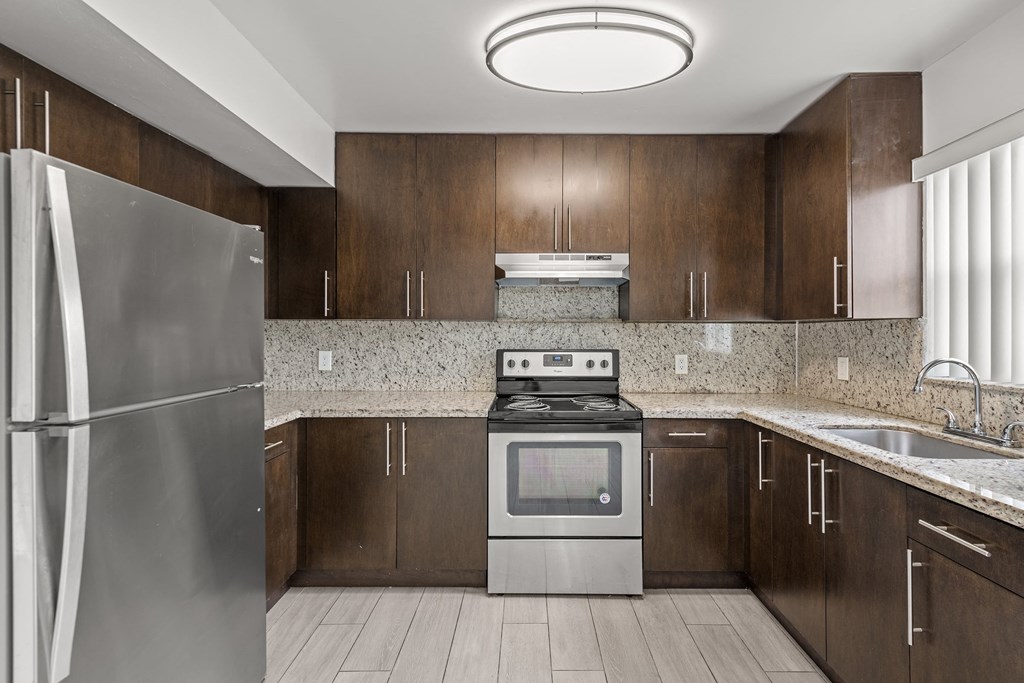 a kitchen with stainless steel appliances and wooden cabinets