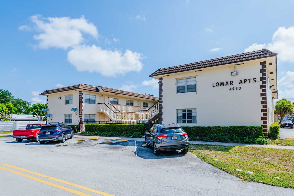the front apartments with cars parked outside