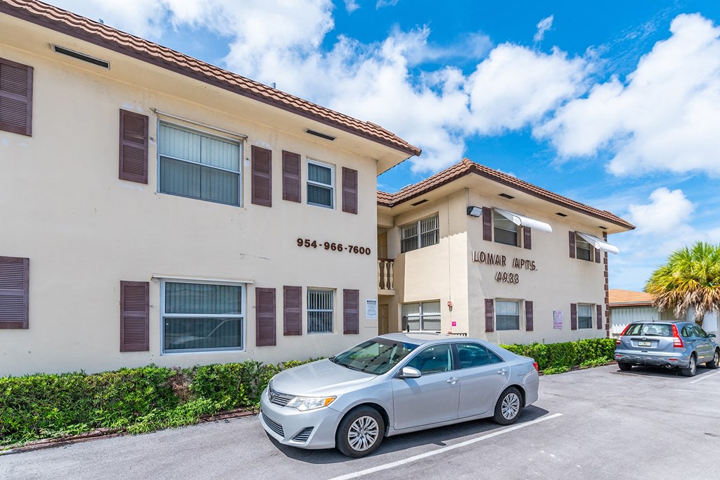 a car parked in front of an apartment building