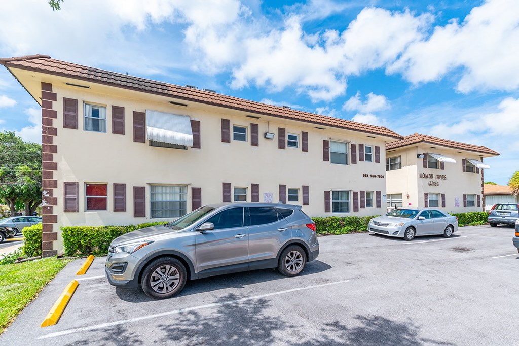 a large building with cars parked in front of it