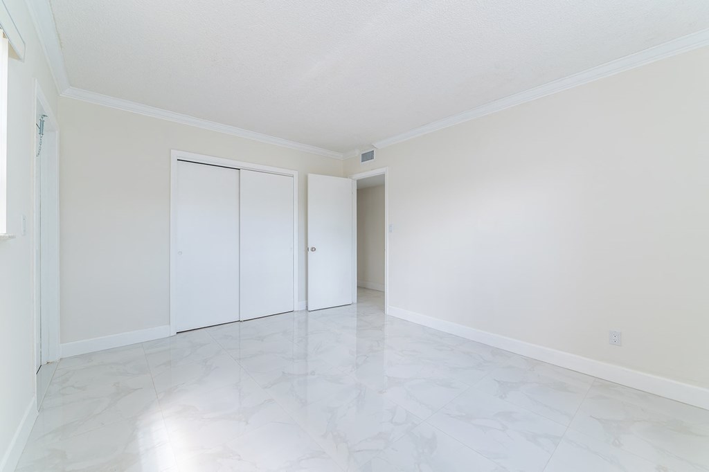 an empty living room with white walls and white doorways