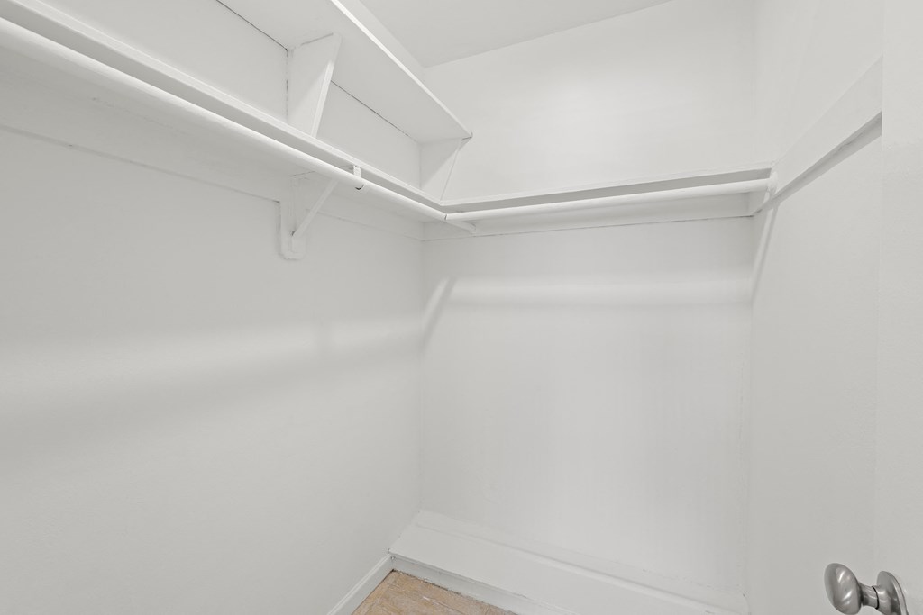 an empty room with white walls and a white ceiling and a silver door