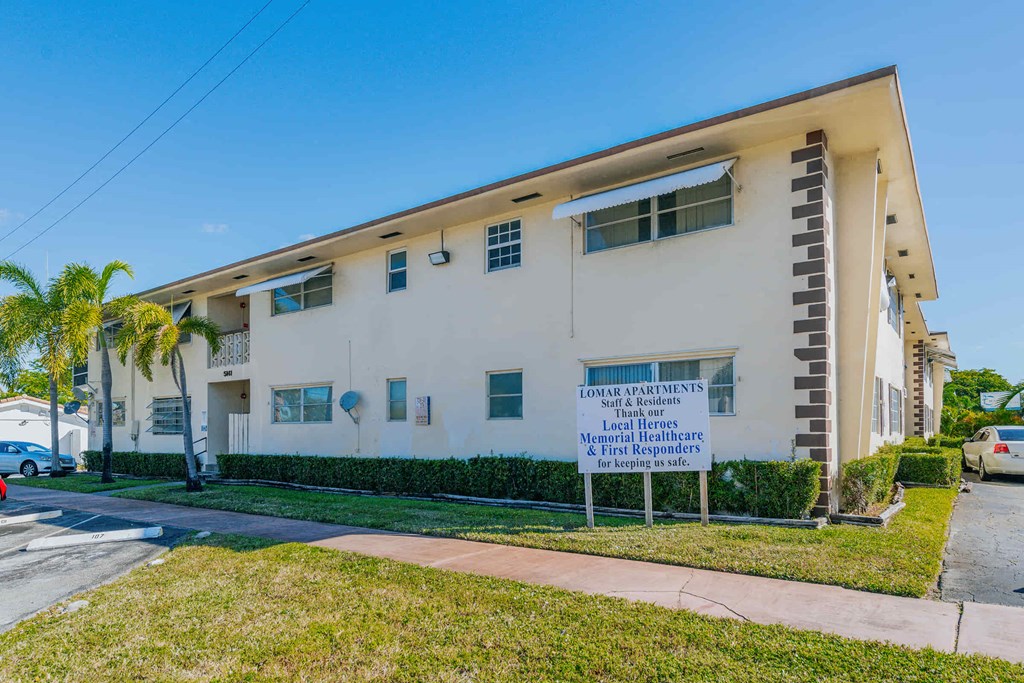 a large white building with a sign in front of it