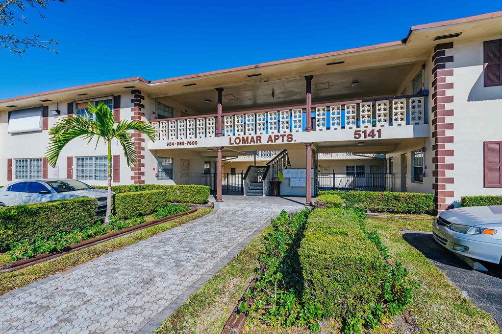 a building with a parking lot and a street in front of it
