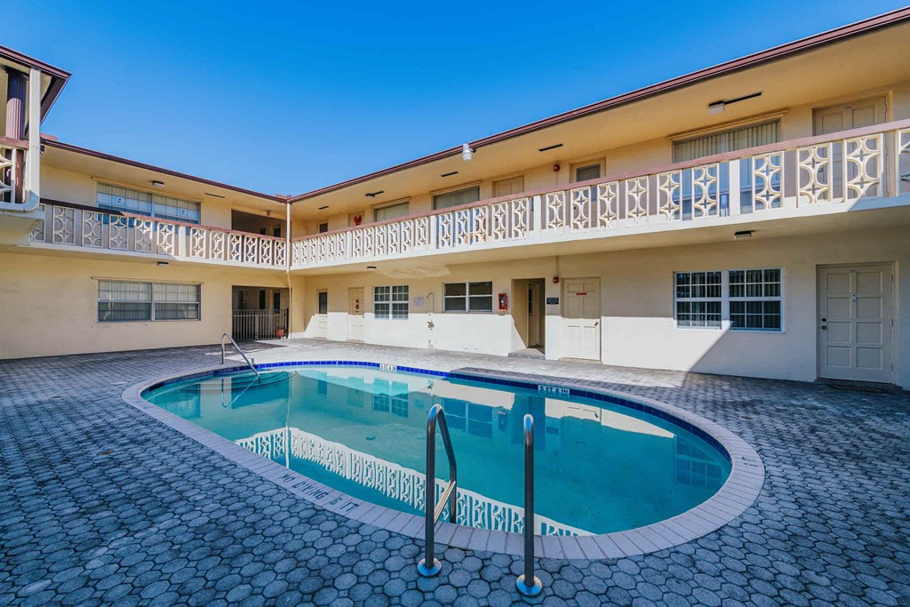 a swimming pool in front of a building with a pool