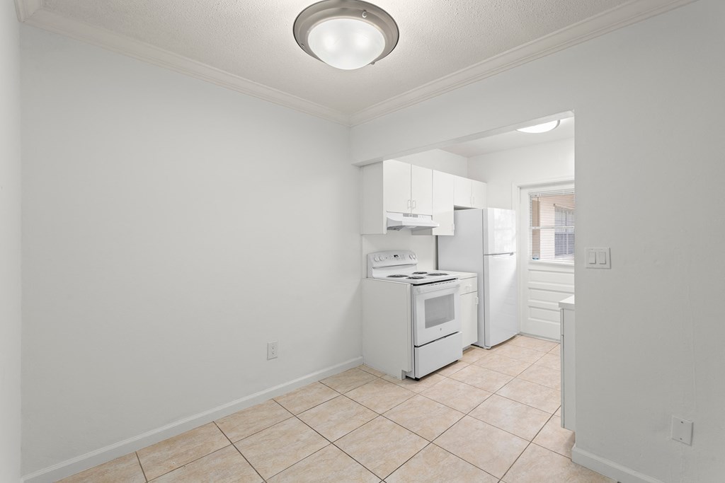 a kitchen with a white stove and a refrigerator