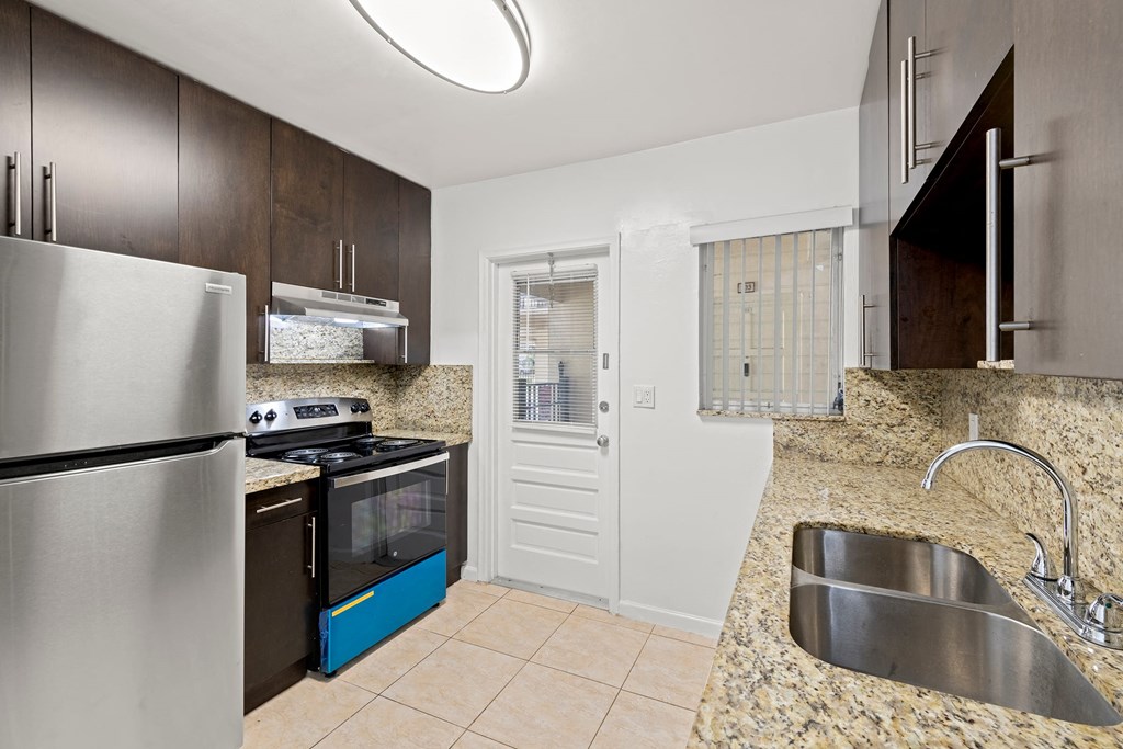 a kitchen with stainless steel appliances and granite counter tops