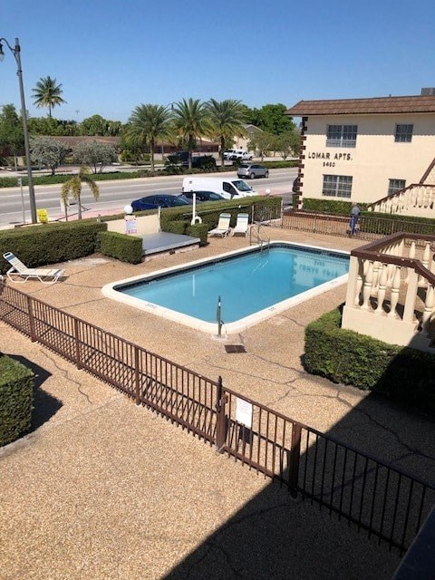 a large swimming pool in front of a building
