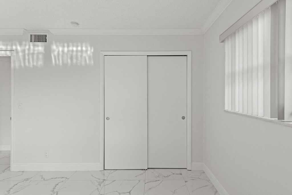 an empty room with white walls and white doors