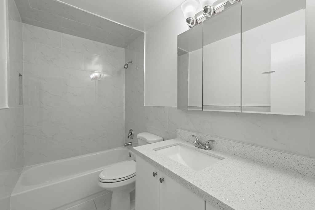 a bathroom with a sink toilet and a bath tub